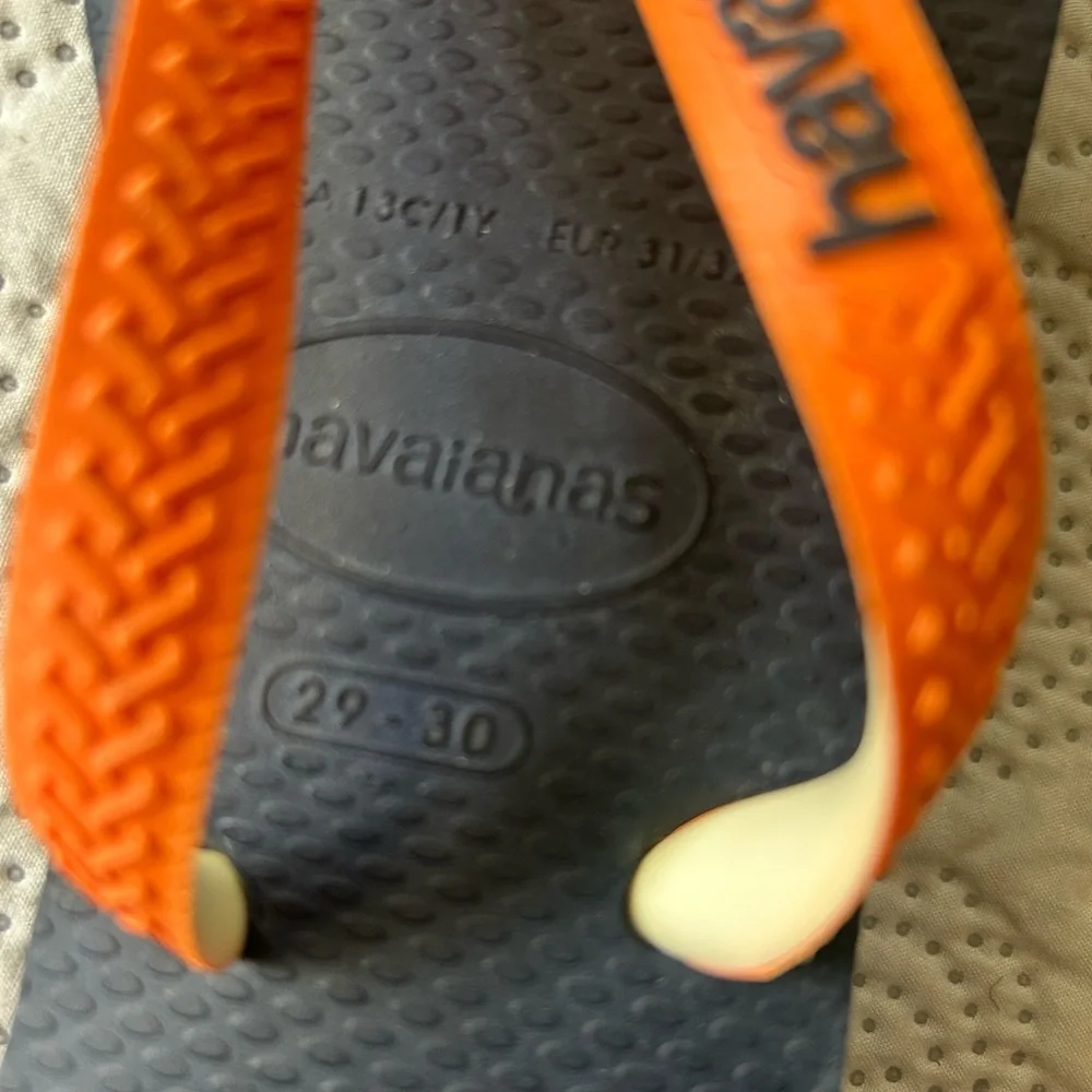 Havana’s flip flops size 29/30 (11-12). Navy base w/orange strap. Great shape!